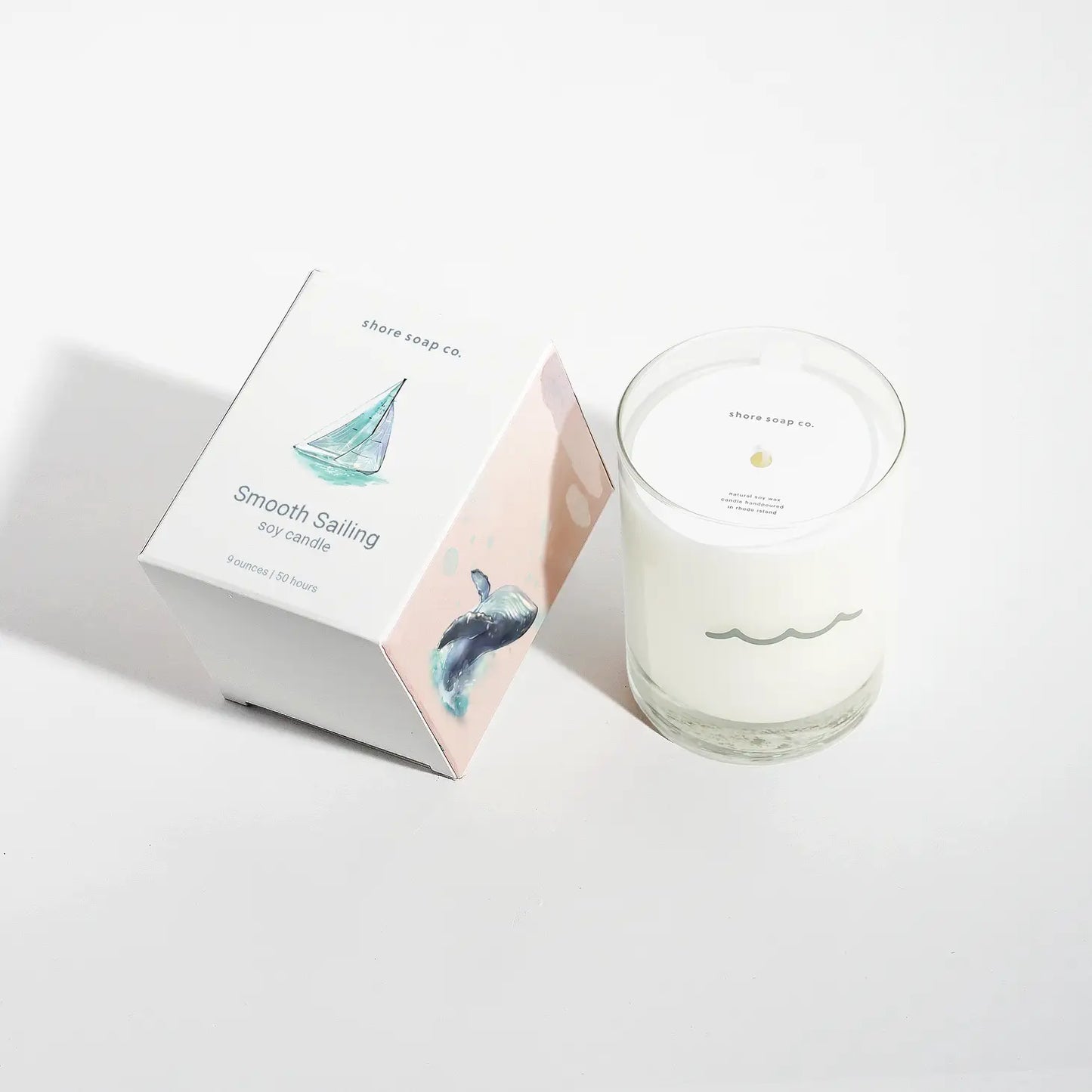 9oz soy candle in re-usable glass container sitting next to its box