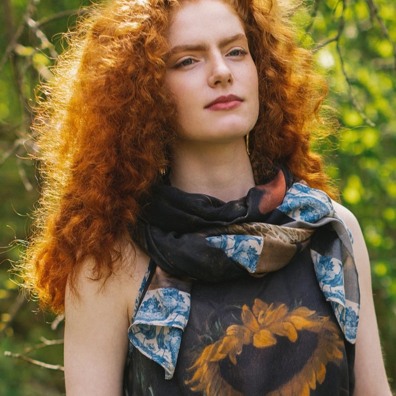 A woman with the Wild Beauty Bohemian Bamboo Scarf with Peacock Print by Market of Stars around her neck as a scarf