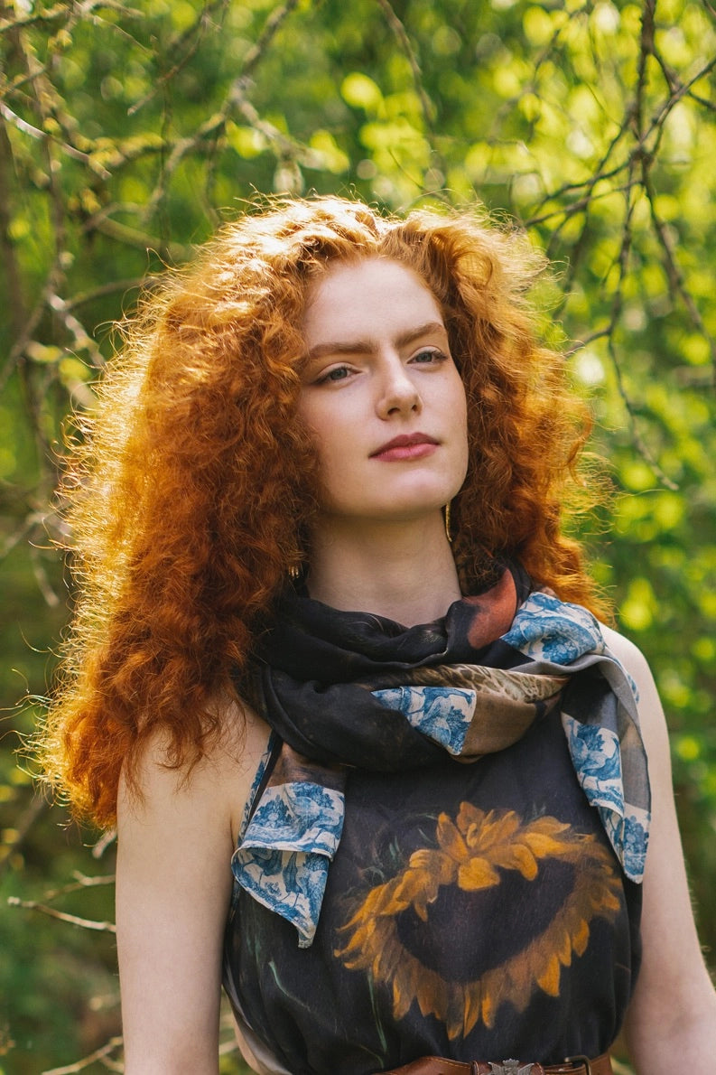 A woman with the Wild Beauty Bohemian Bamboo Scarf with Peacock Print by Market of Stars around her neck as a scarf