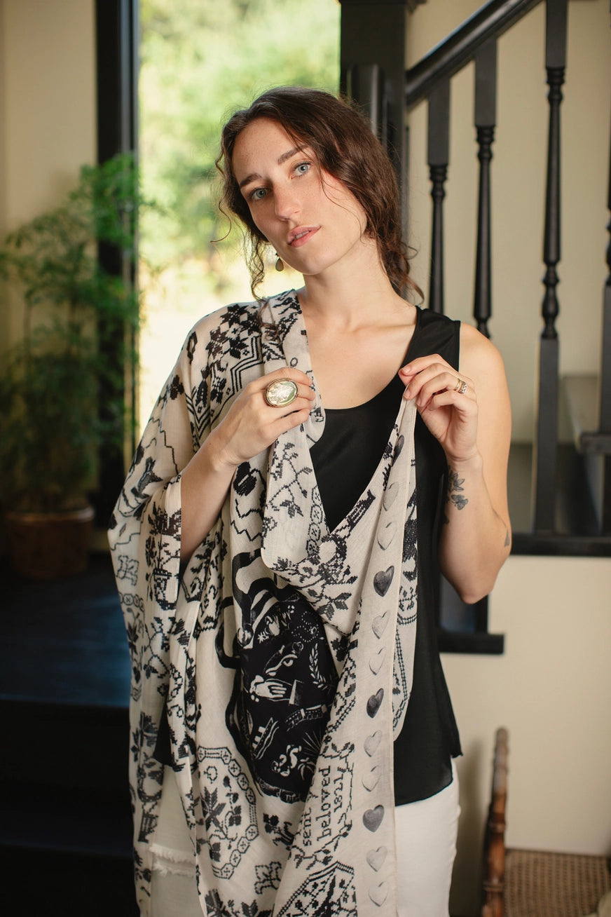 A woman with the Token of Love Printed Bamboo Scarf by Market of Stars draped over her shoulder