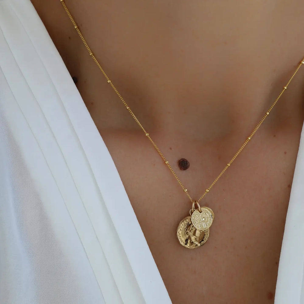 
                      
                        Woman wearing the Coin Charm Necklace by Katie Waltman Jewelry
                      
                    