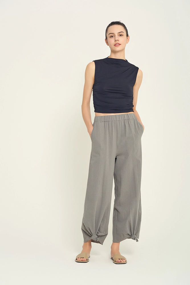 
                      
                        Front view of woman wearing grey knotted hem pants
                      
                    