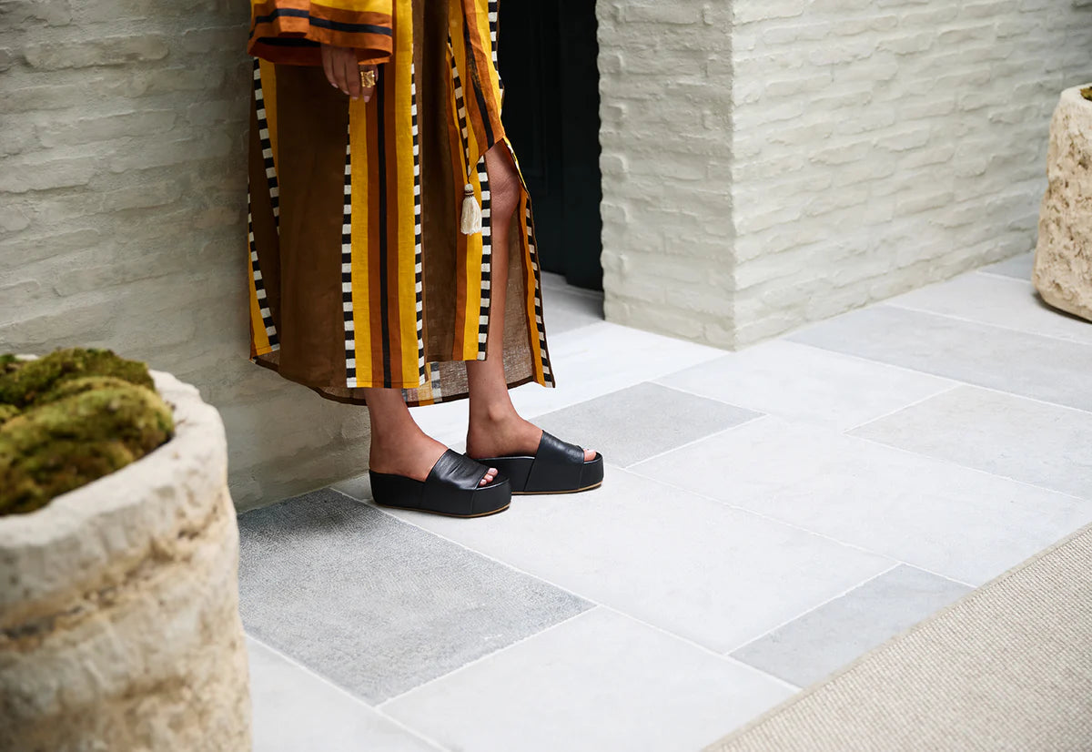 A person wearing the Black Albatross Leather Platform Sandal by beek