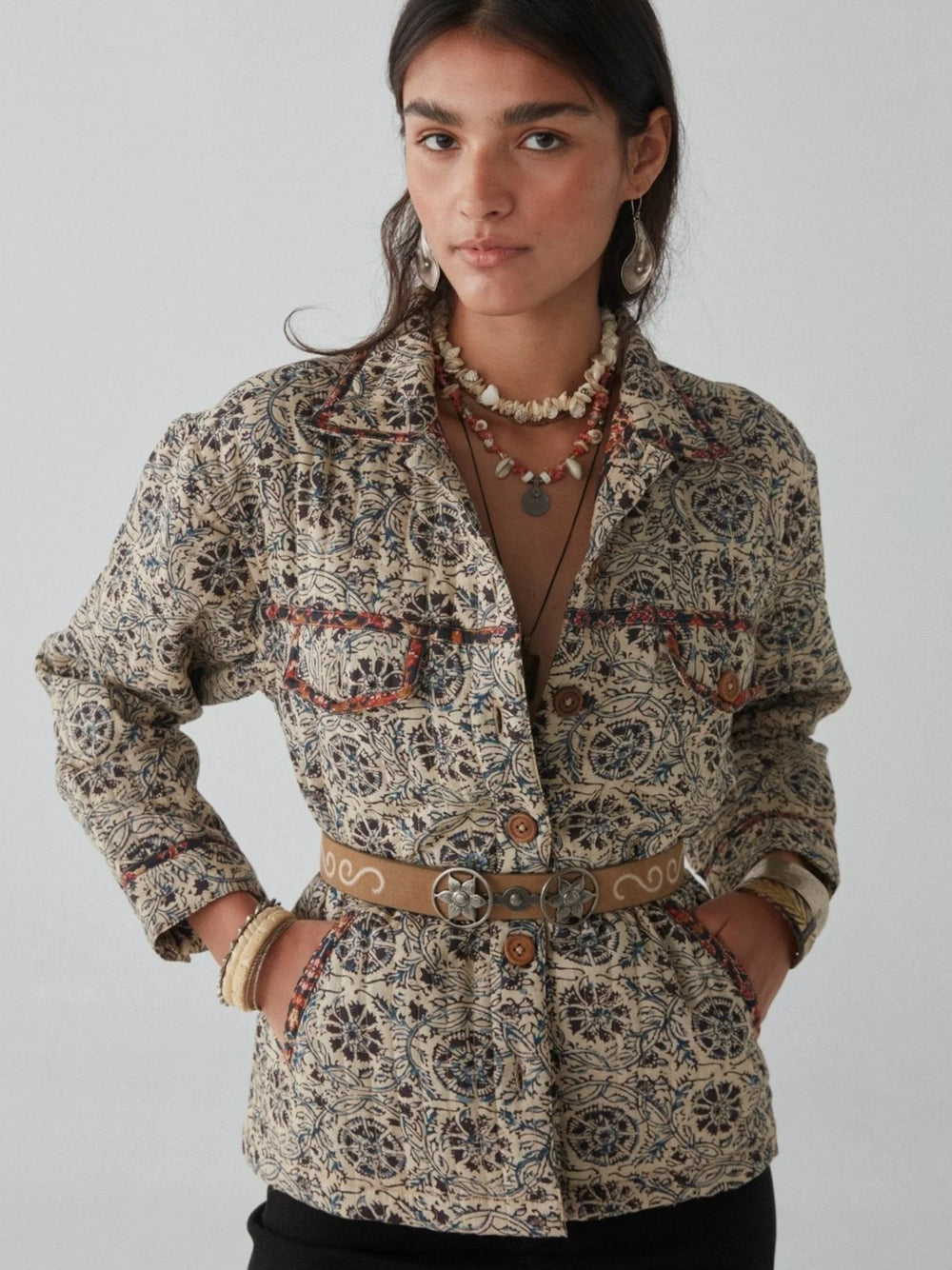 a woman wearing the Anoushka Jacket by Maison Hotel with a belt around it