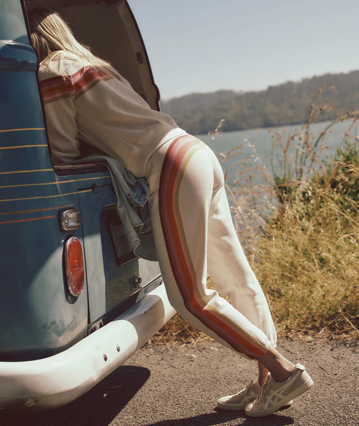 
                      
                        A woman leaning into a van while wearing the Anytime Sweatpants by Marine Layer
                      
                    