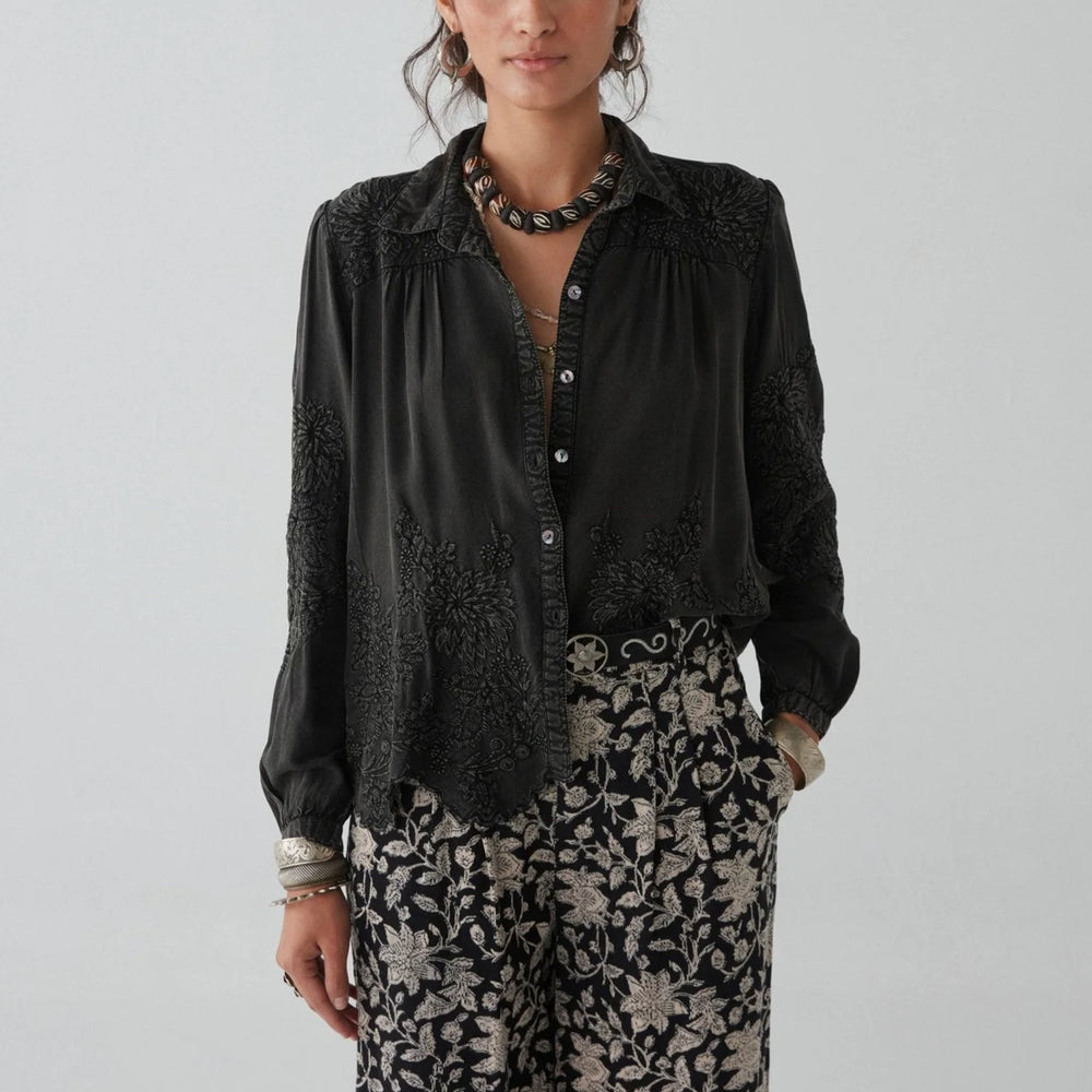 
                      
                        A woman wearing the Ariana Blouse by Maison Hotel
                      
                    