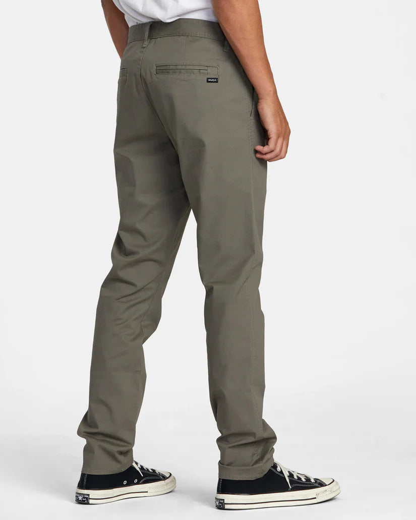 Back view of a man wearing the Olive Green Daggers Technical Chinos by RVCA