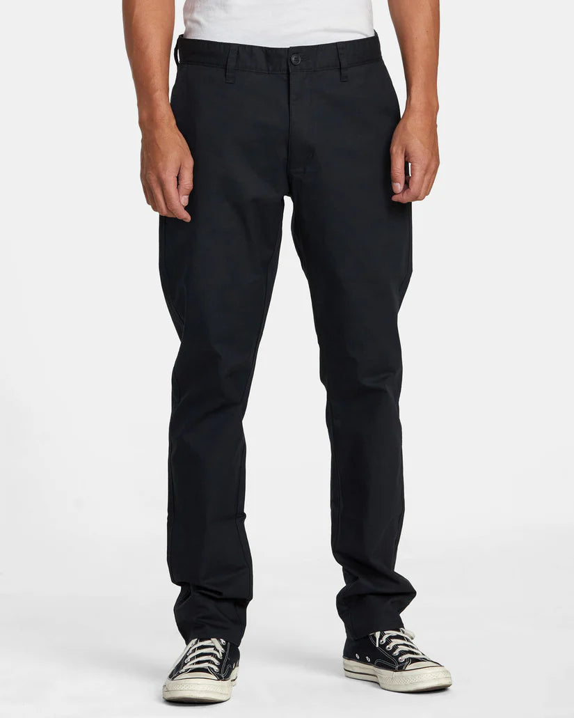 Front view of a man wearing the Black Daggers Technical Chinos by RVCA