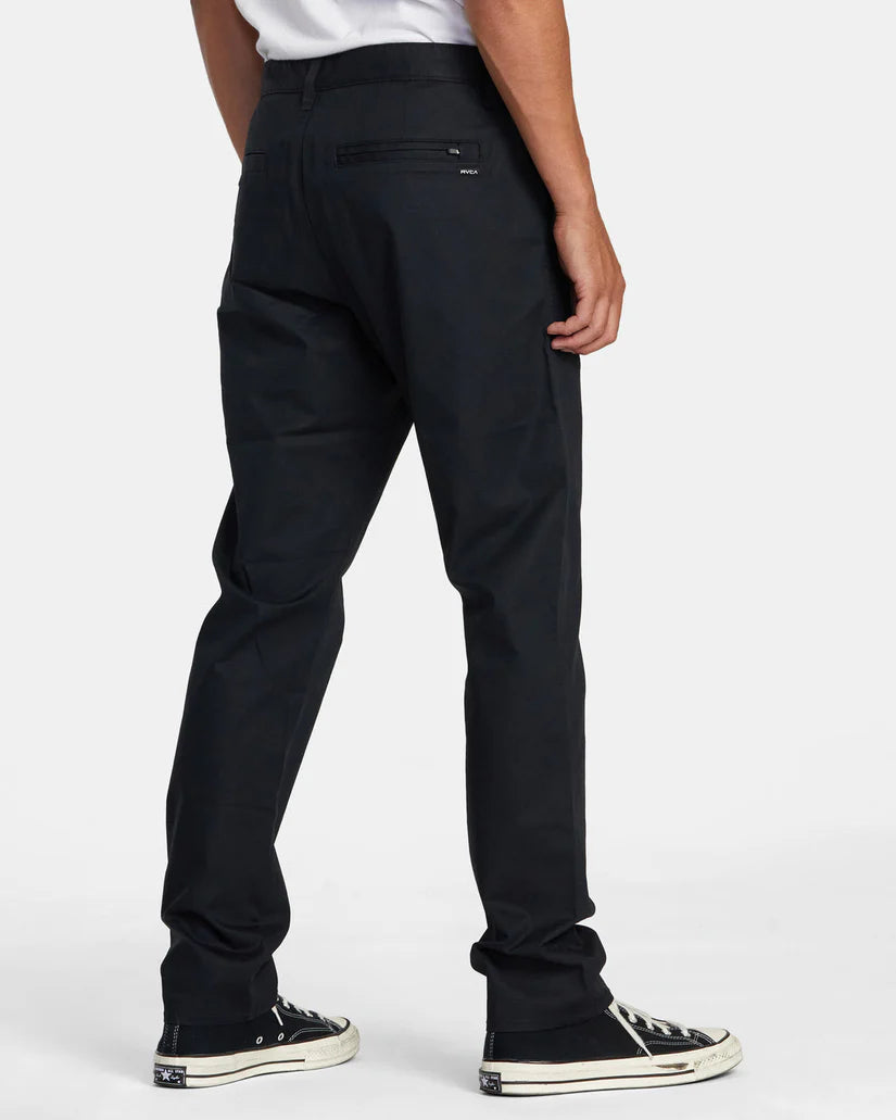 Back view of a man wearing the Black Daggers Technical Chinos by RVCA