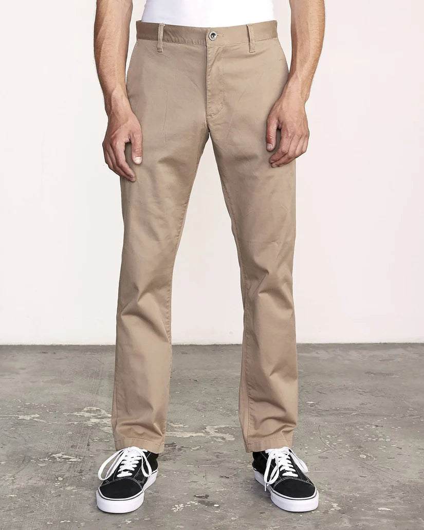 Front view of a man wearing the Dark Khaki Weekend Stretch Straight Fit Pants by RVCA