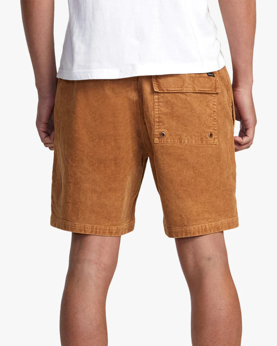 Back view of man wearing 17" elastic waist brown corduroy men's shorts by RVCA