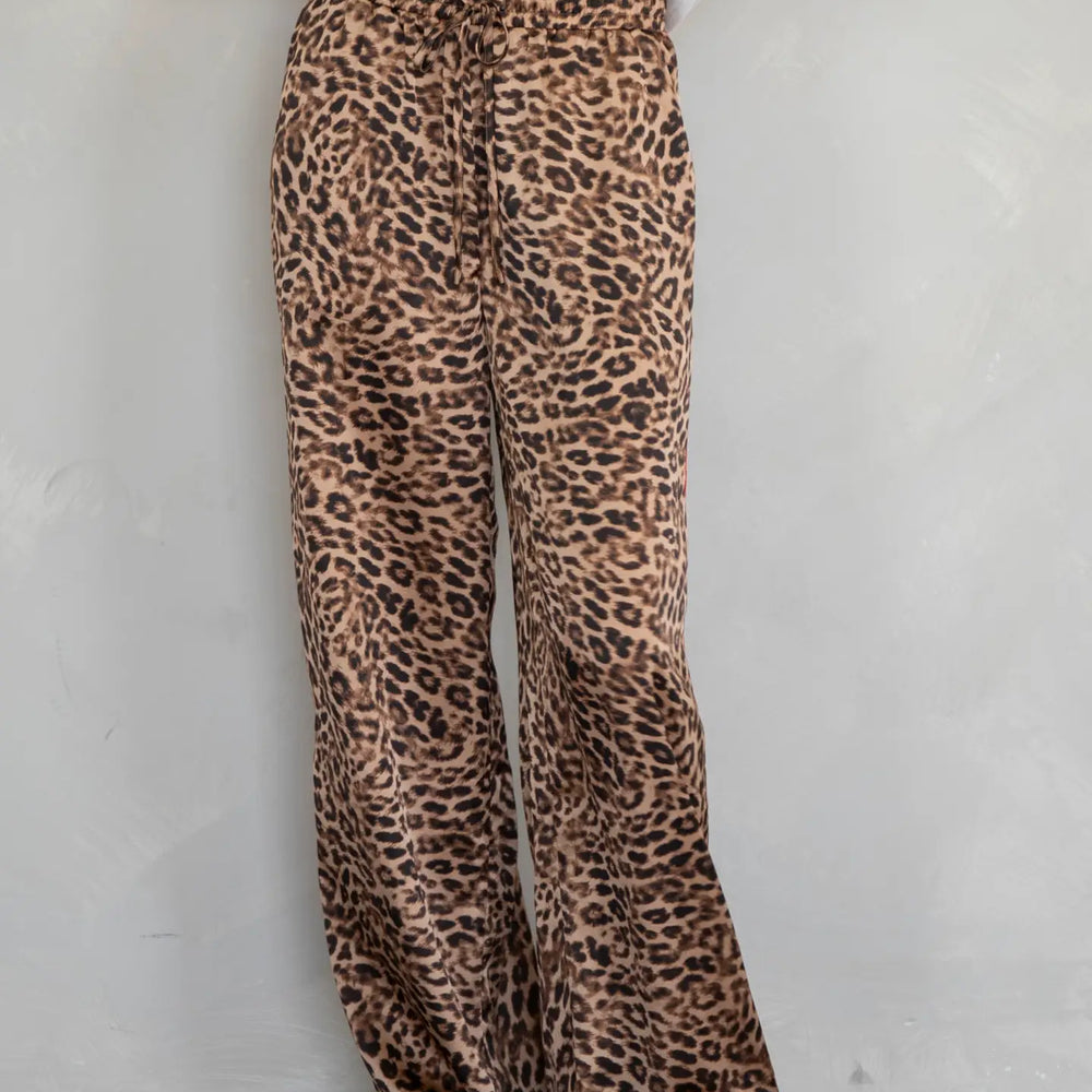 Relax in bold style with these soft and silky leopard lounge pants with a red stripe detail down the sides. Available now at Harbour Thread in Burlington, VT!