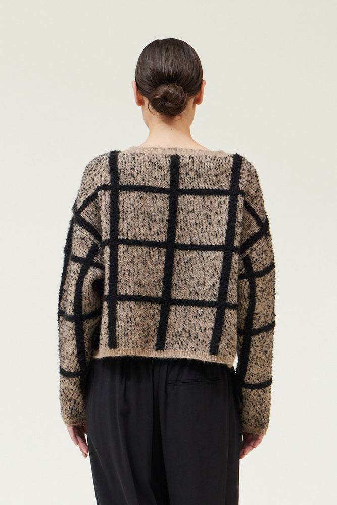 Back view of a woman wearing a Cropped Grid Sweater by Grade & Gather