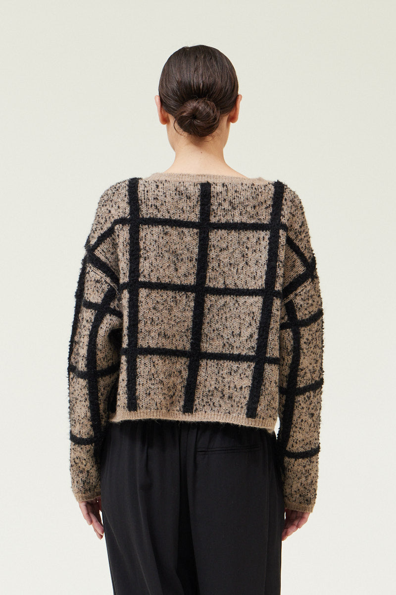 Back view of a woman wearing a Cropped Grid Sweater by Grade & Gather