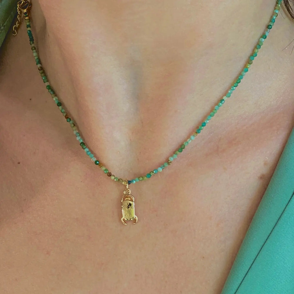 
                      
                        Woman wearing the Lou Beetle Scarab Necklace by Sophie Deschamps Bijoux
                      
                    