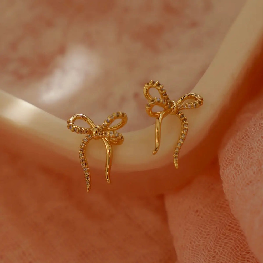 
                      
                        Find the Yellow Gold CZ Bow Studs by Katie Waltman Jewelry at Harbour Thread
                      
                    