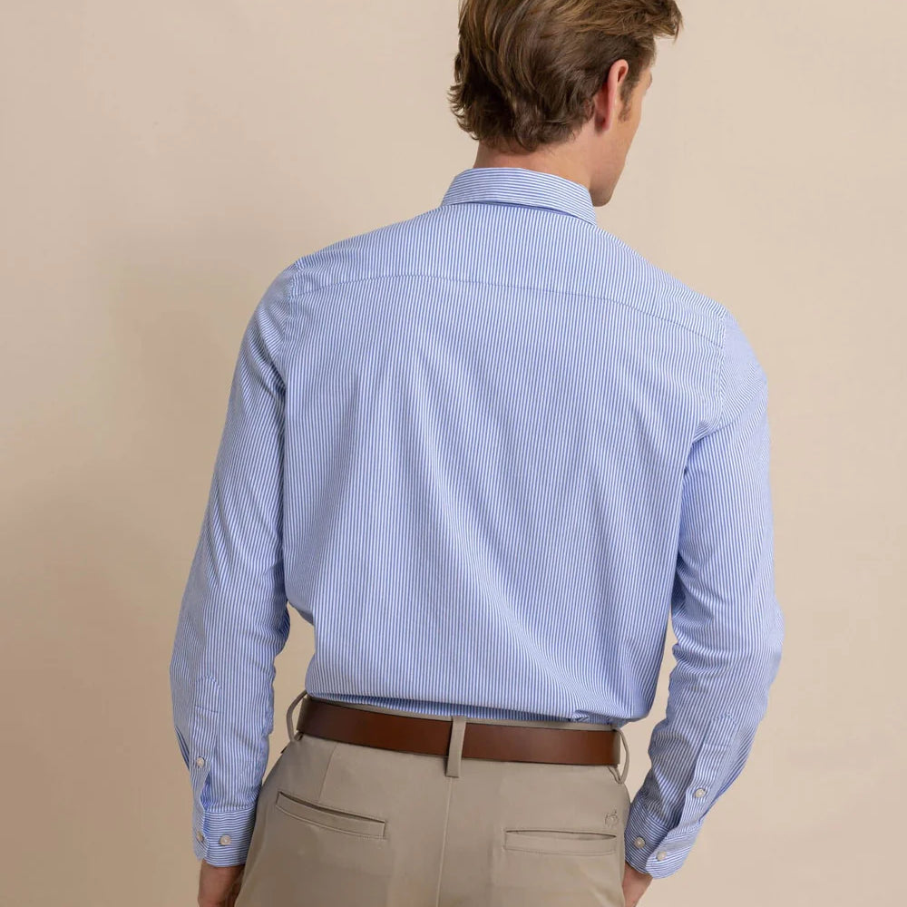 back view of man wearing a blue and white pinstriped long sleeve button up shirt by Southern Tide