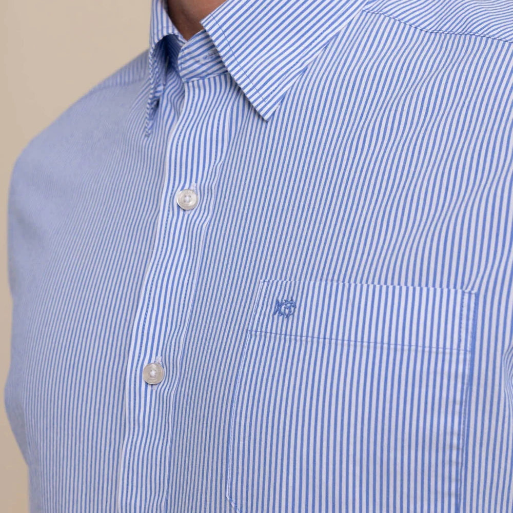 
                      
                        Closeup front view of man wearing a blue and white pinstriped long sleeve button up shirt by Southern Tide
                      
                    