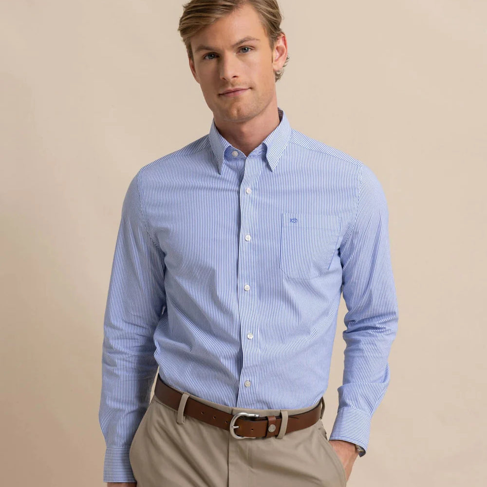 Front view of man wearing a blue and white pinstriped long sleeve button up shirt by Southern Tide