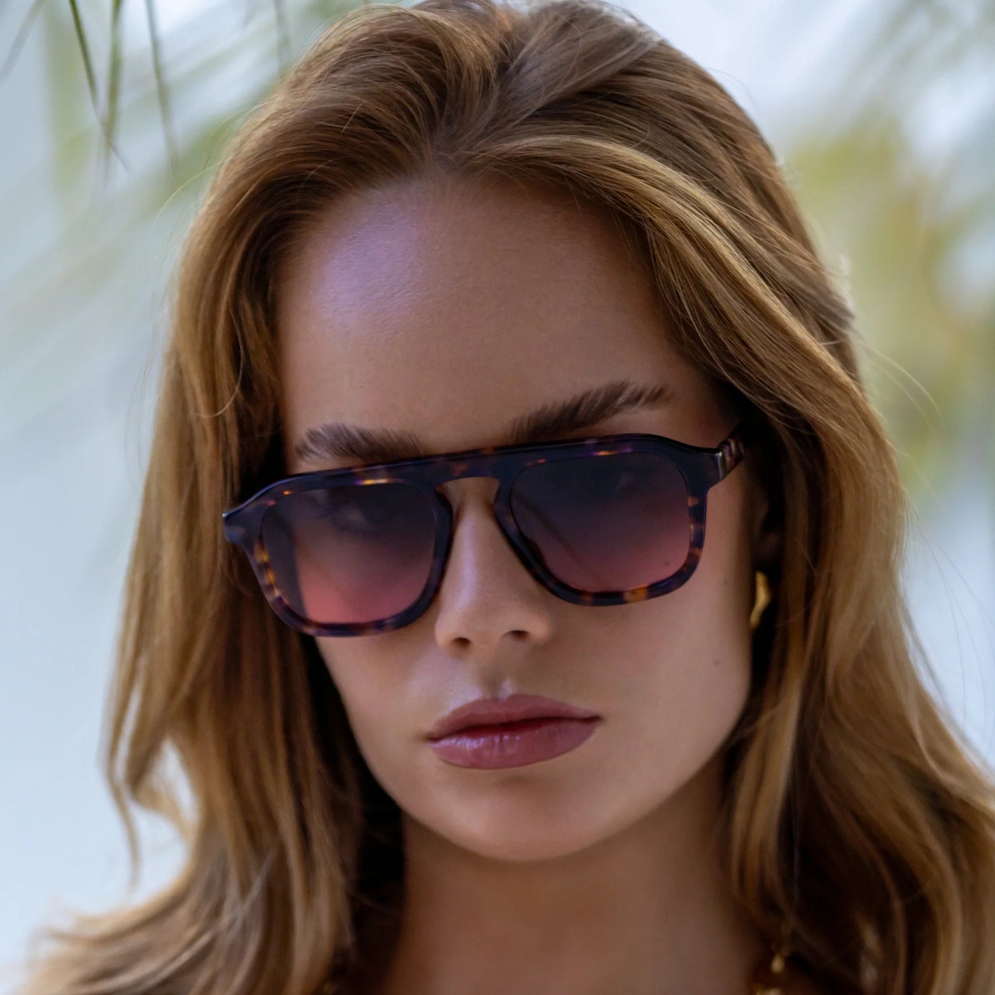 A woman wearing the FREYRS Addison Unisex Aviator Sunglasses