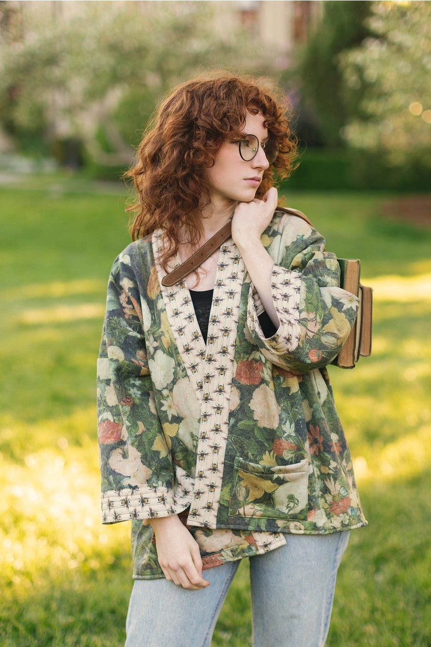 Front view of a woman wearing the I Dream in Flowers Cozy Bees Fleece Cardigan Kimono Jacket by the brand Market Of Stars. 