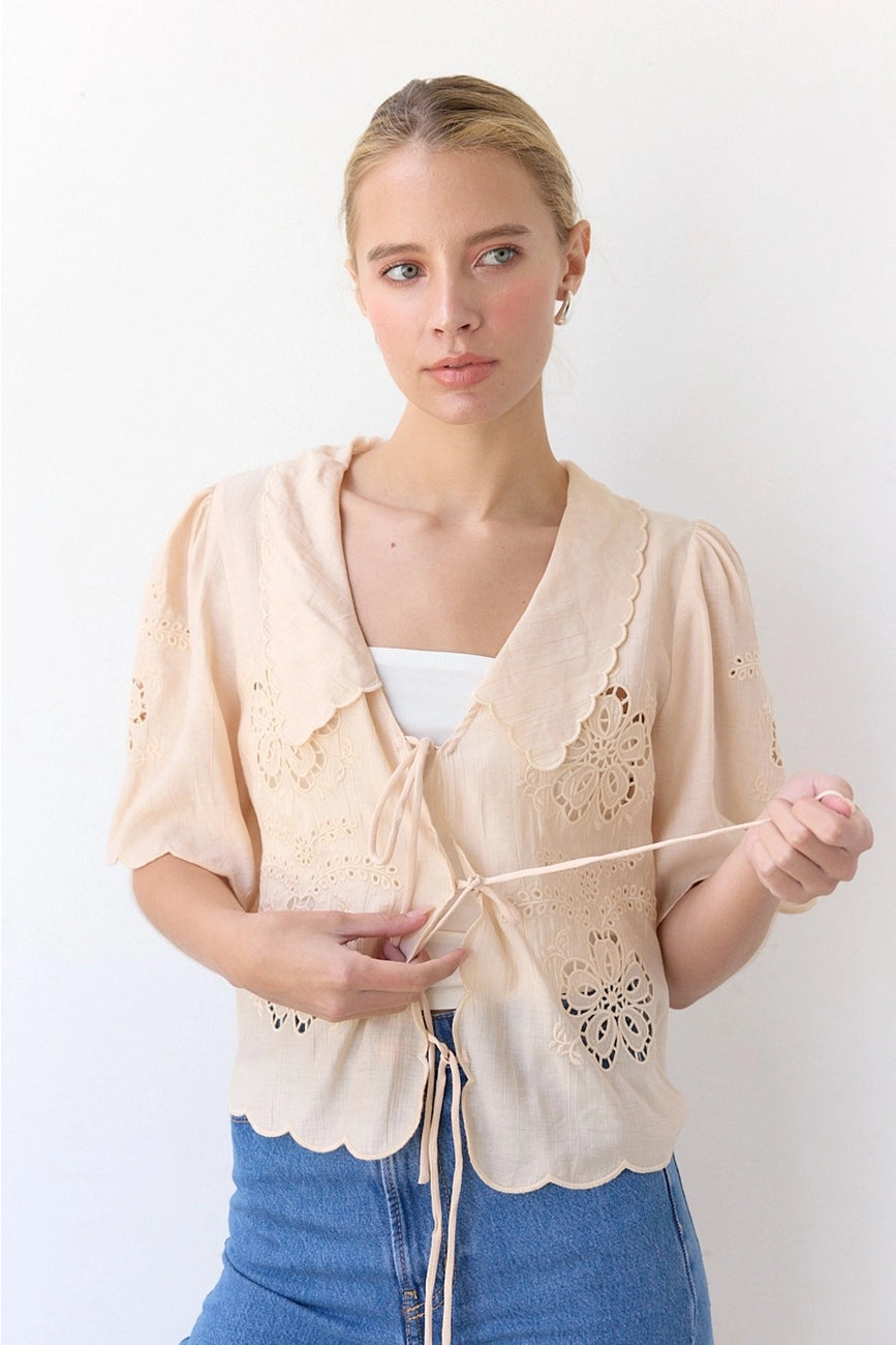 Embrace feminine warm-weather style with this embroidered tie-front top at Harbour Thread women's boutique in Burlington, VT. 