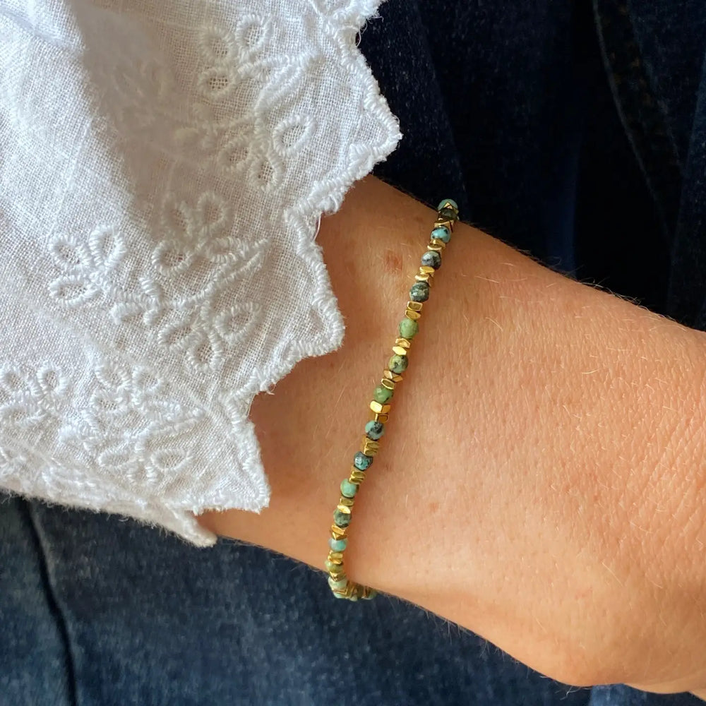Close-up of a wrist wearing a green turquoise bracelet
