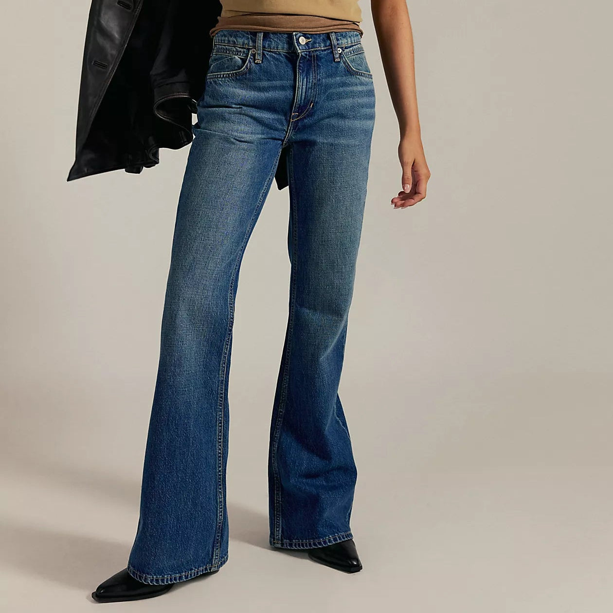 A woman wearing relaxed fit flare jeans from Free People