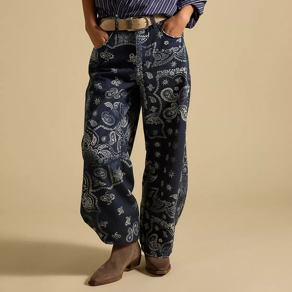 Woman wearing a striped shirt and patterned barrel jeans from Free People