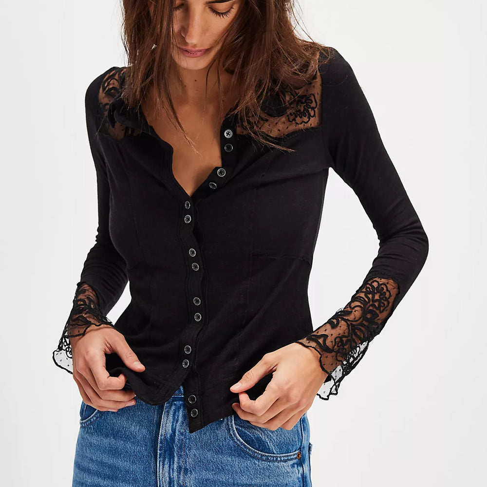 
                      
                        Woman wearing a black long-sleeve top with lace details and blue jeans on a white background
                      
                    