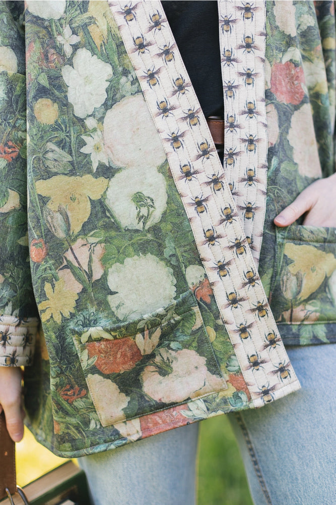 
                      
                        Design detail on the  I Dream in Flowers Cozy Bees Fleece Cardigan Kimono Jacket by the brand Market Of Stars. 
                      
                    