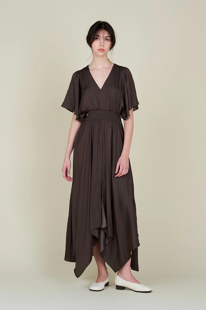 This dark brown women's maxi dress from Grade and Gather features flutter sleeves, a smocked waist, and handkerchief skirt. Shop now at Harbour Thread. 
