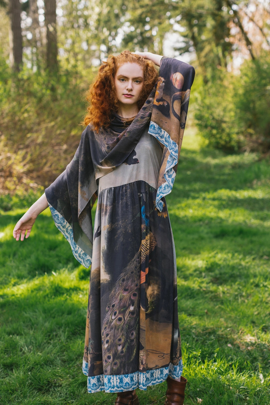 A woman wearing the Wild Beauty Bohemian Bamboo Scarf with Peacock Print by Market of Stars