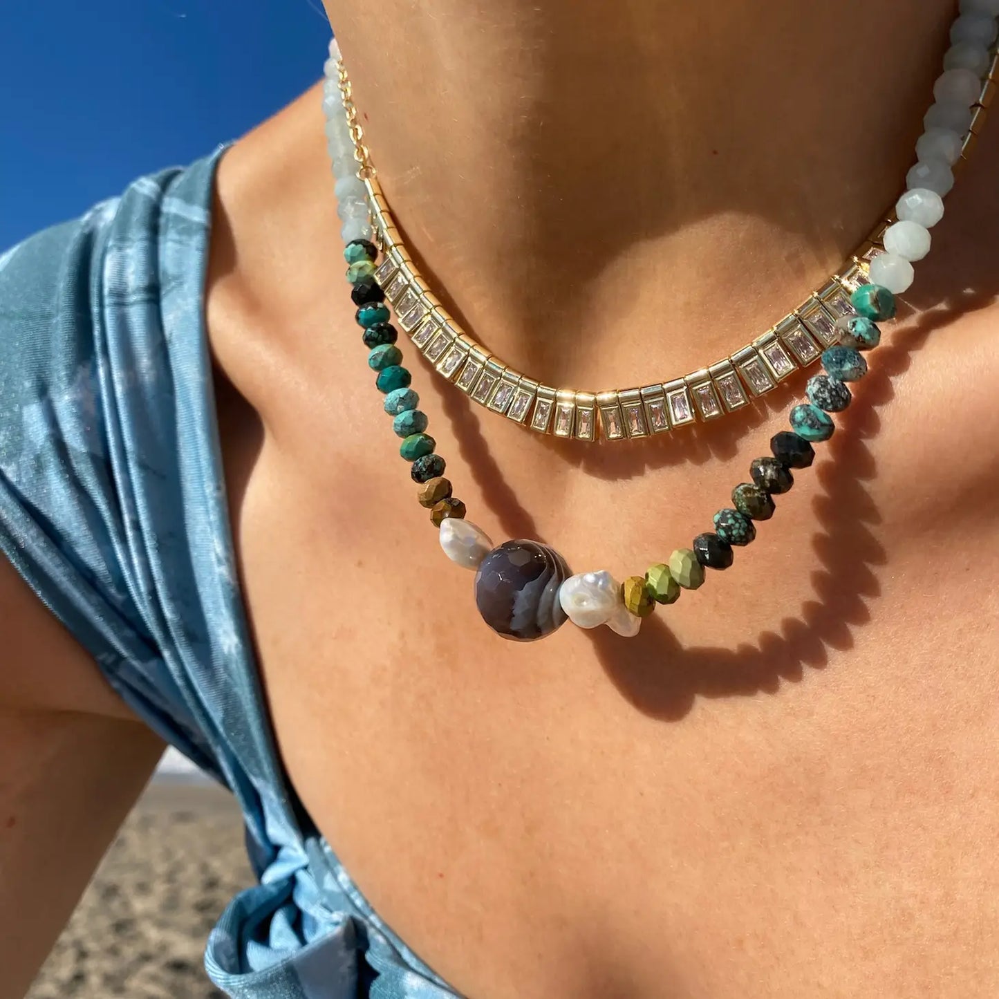 Woman wearing the Olympia multi stone necklace by Native Gem