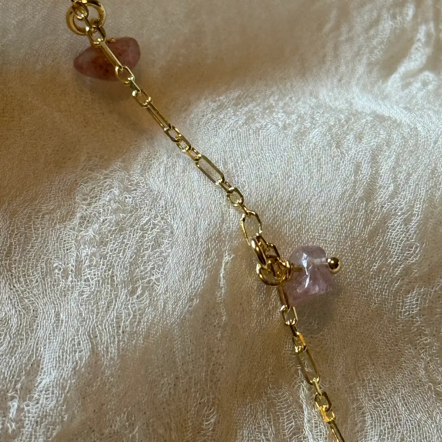A Dainty 925 sterling silver gold vermeil plated chain with dangling strawberry quartz stones