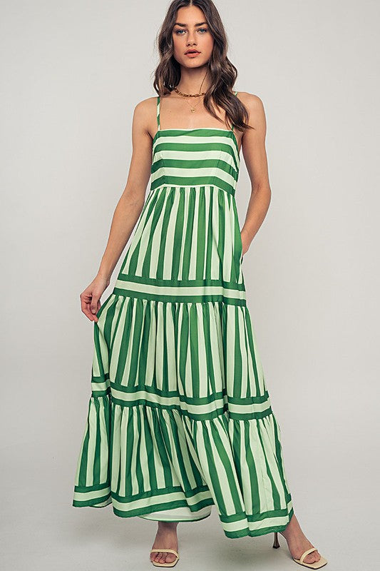 This striking maxi dress at Harbour Thread features bold green stripes and tiered construction — perfect for elevated summer styling.