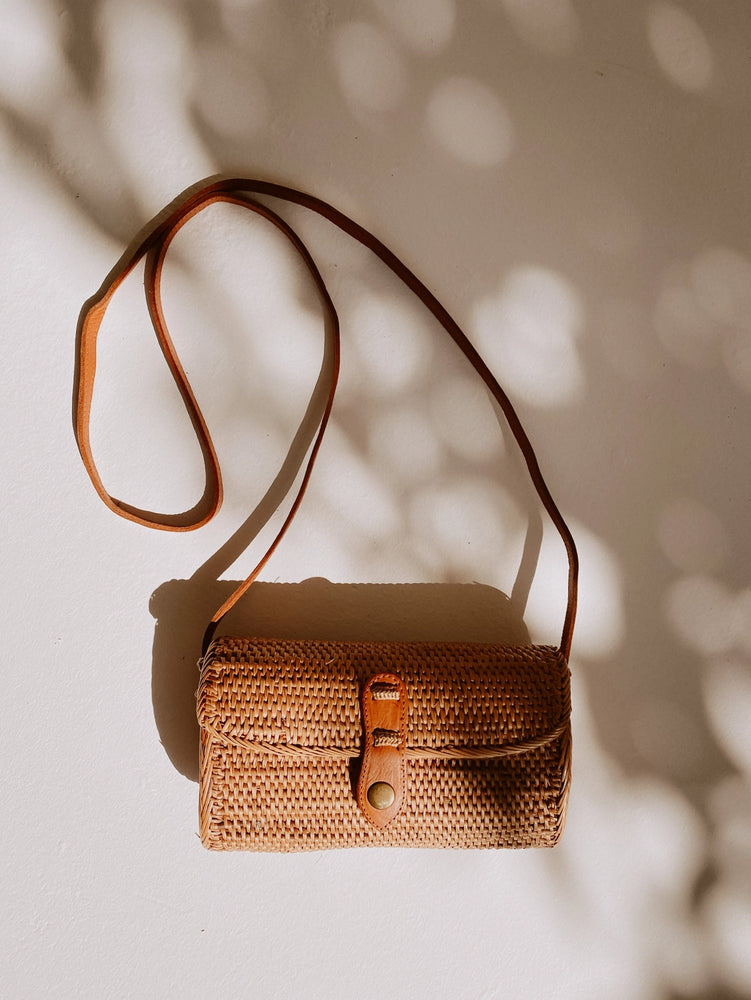 
                      
                        Flat lay view of the Ulan Rattan Purse by Village Thrive
                      
                    