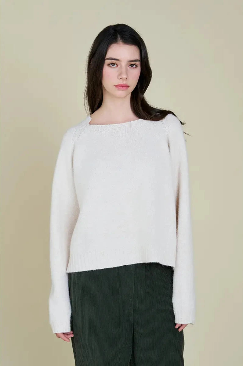 This pullover sweater features a unique neckline detail that squares off at the front