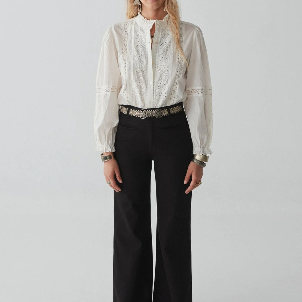 
                      
                        An outfit styled with black wide leg jeans, a belt and the Emmanuelle Blouse by Maison Hotel 
                      
                    