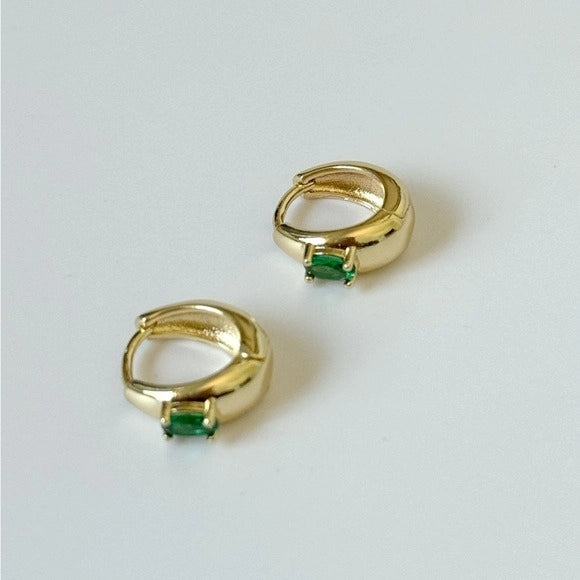Gold hoop earrings with green gemstones 