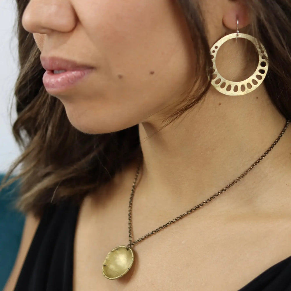Woman wearing the Brass Lotus Root Earrings by Jennifer Kahn Jewelry
