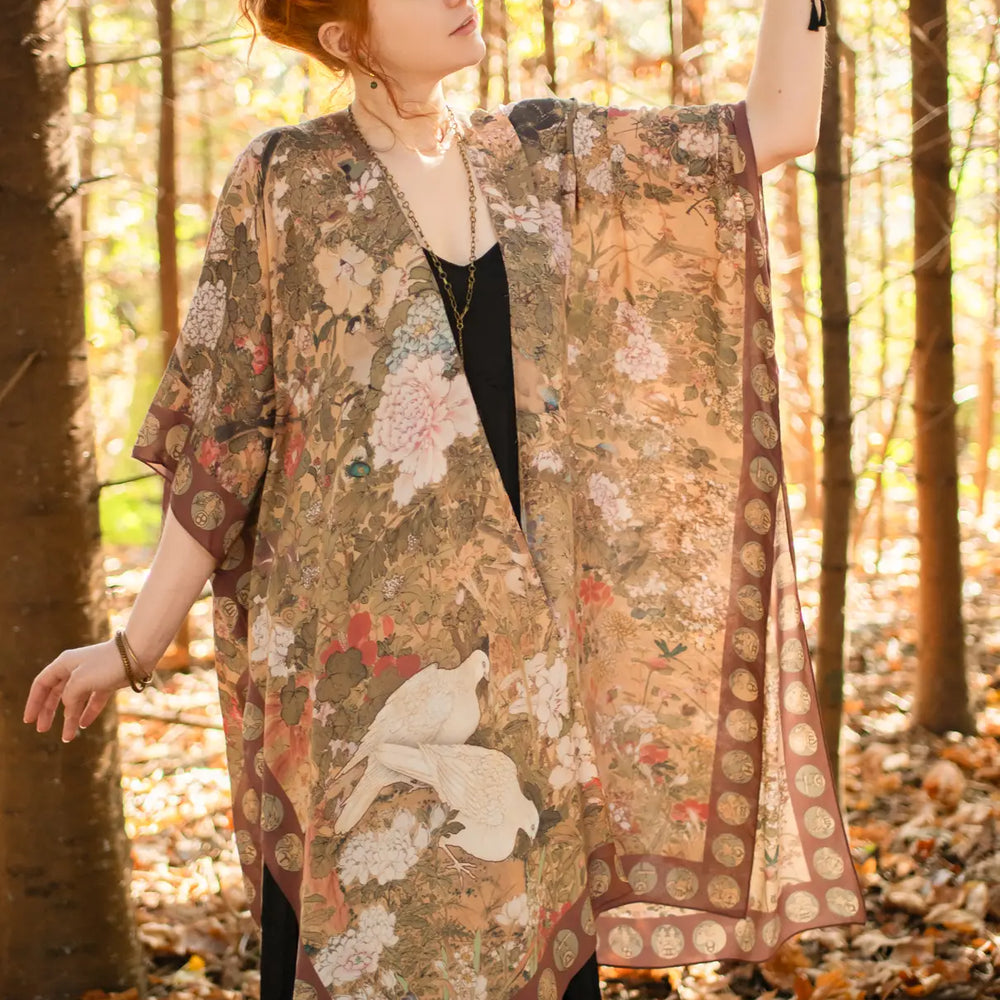 
                      
                        A woman in the forest wearing the Dreamweaver Zodiac Kimono by Market Of Stars
                      
                    