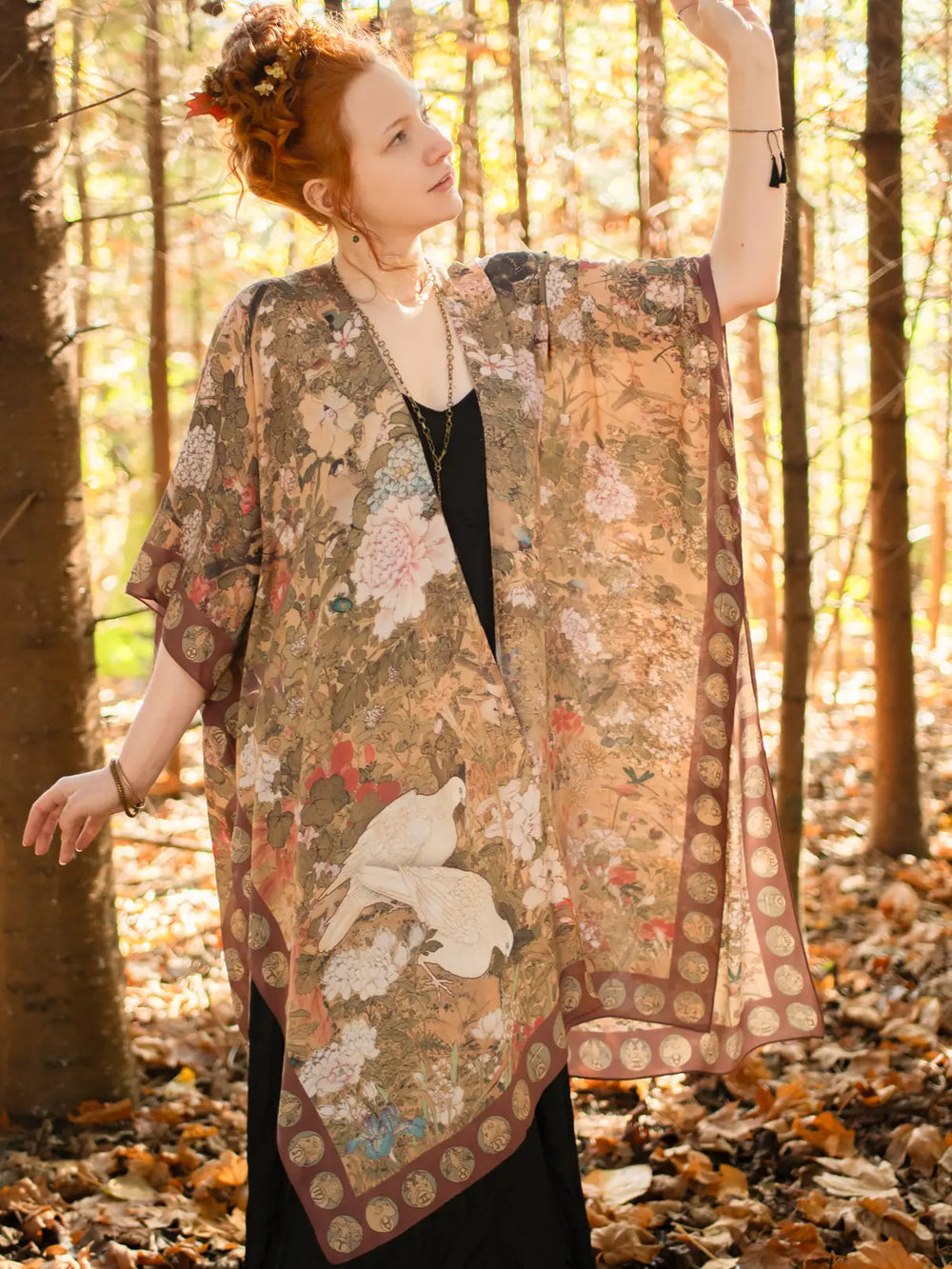 A woman in the forest wearing the Dreamweaver Zodiac Kimono by Market Of Stars