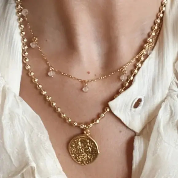 The Tramps + Thieves Amor Y Sol Choker Necklace layered with a beaded medallion necklace