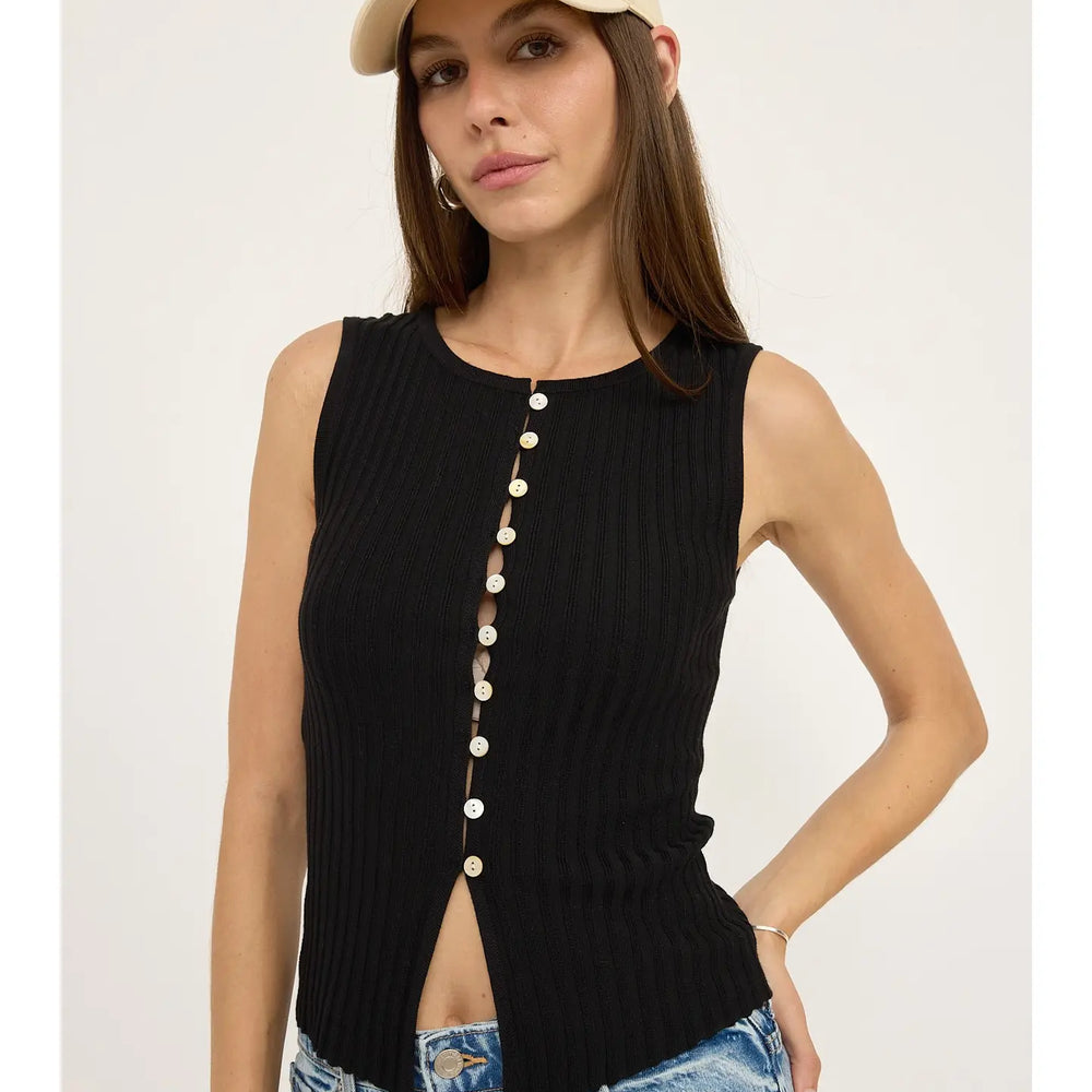 This sleeveless knit top offers a form-fitting silhouette with front button closure and scoop neckline. Find yours at Harbour Thread boutique in Burlington, VT!