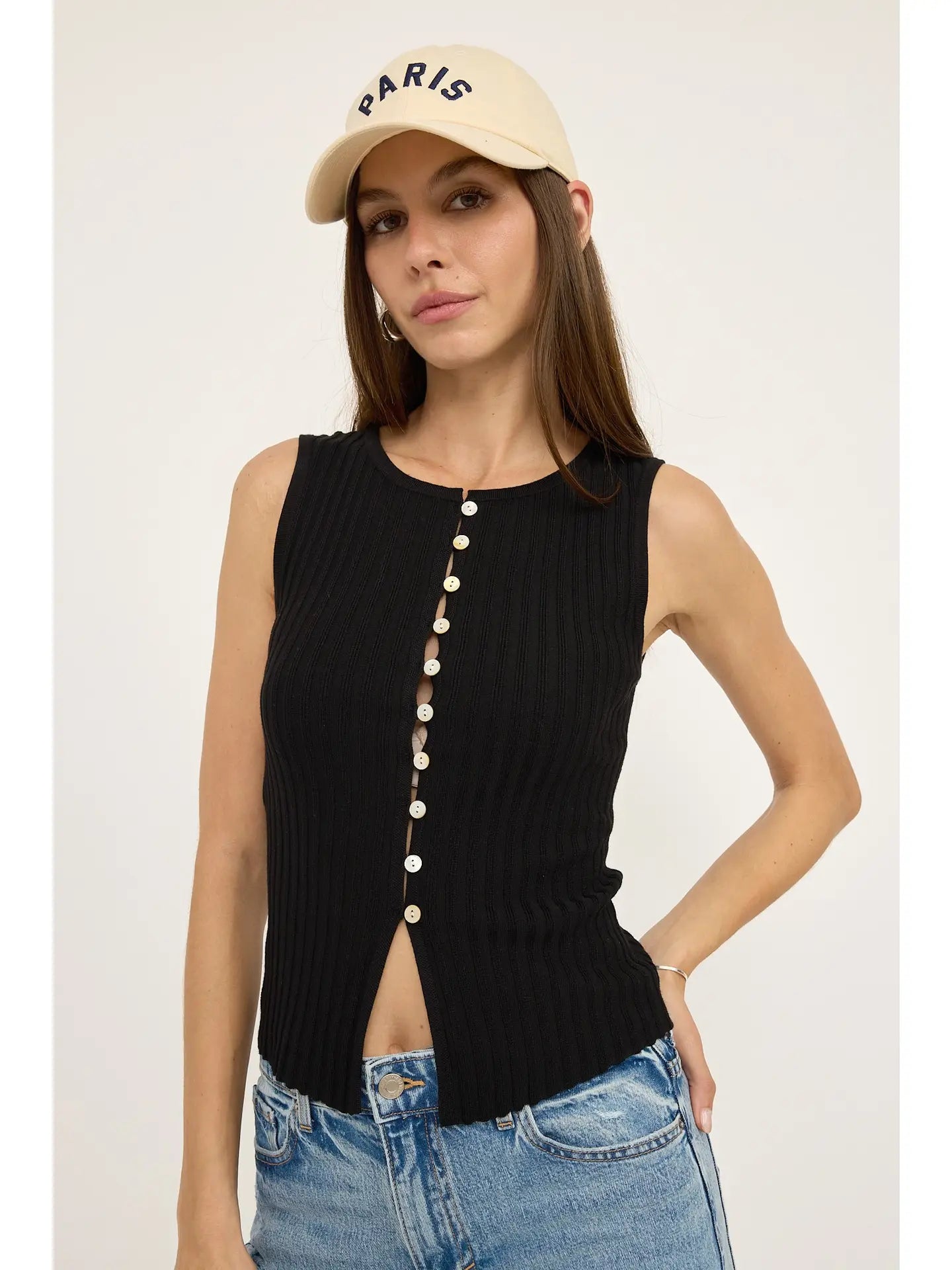 This sleeveless knit top offers a form-fitting silhouette with front button closure and scoop neckline. Find yours at Harbour Thread boutique in Burlington, VT!