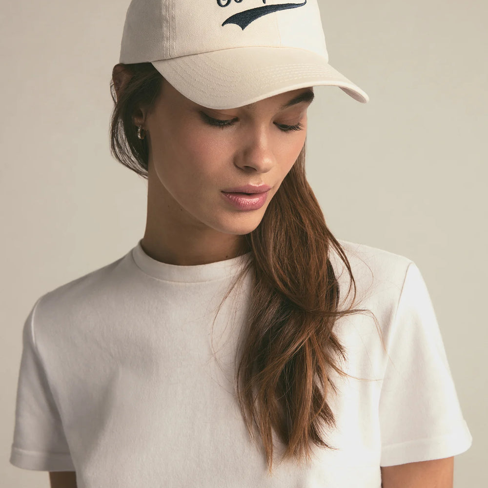 A woman wearing the Favorite Daughter Go Sports Hat in the color Khaki