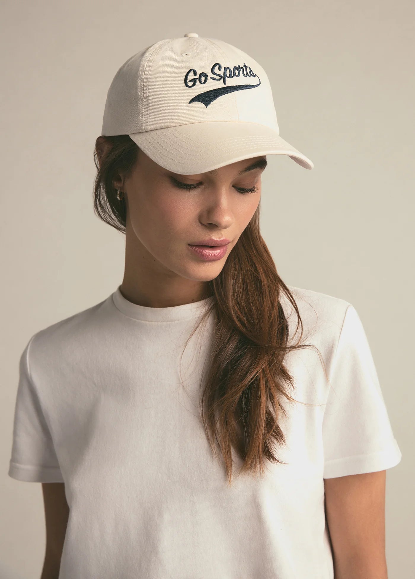 A woman wearing the Favorite Daughter Go Sports Hat in the color Khaki
