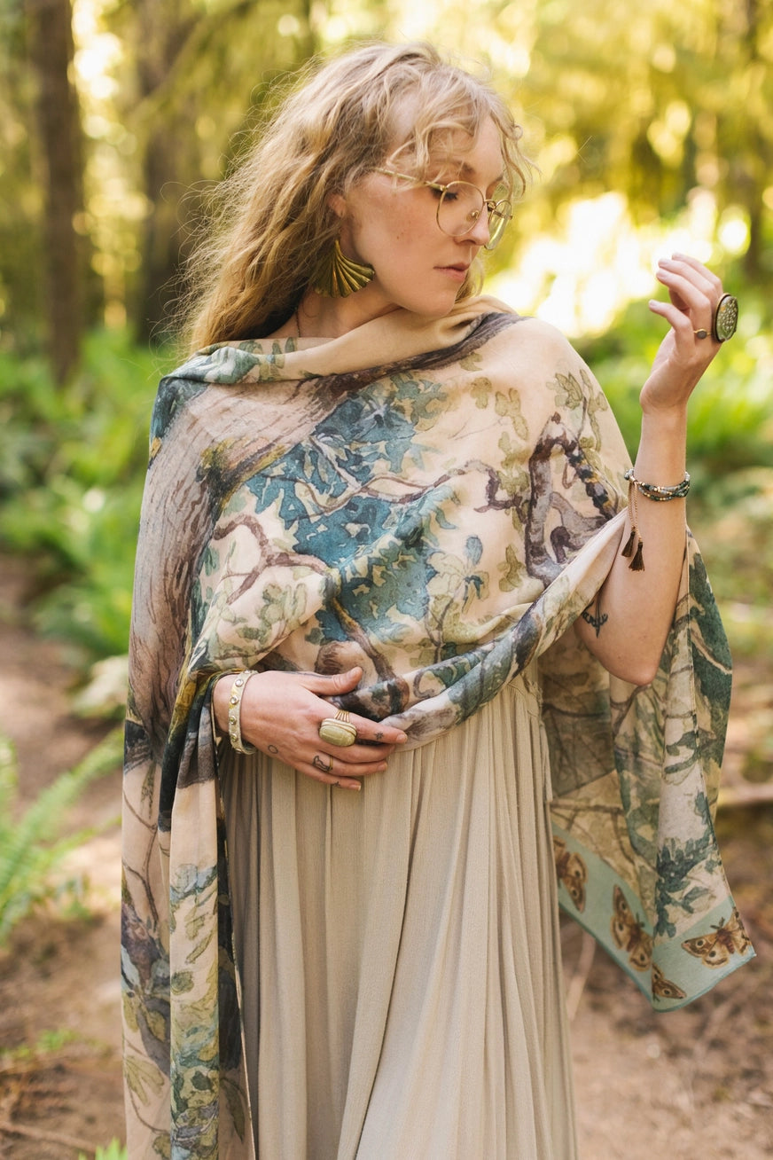 A woman with the Earth and Sky Bohemian Bamboo Scarf with Tree Print by Market of Stars draped over her