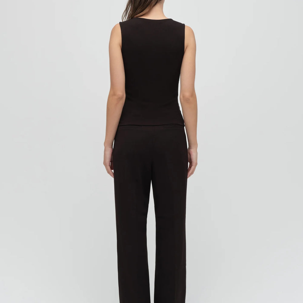 
                      
                        Woman wearing a black sleeveless top and pants
                      
                    